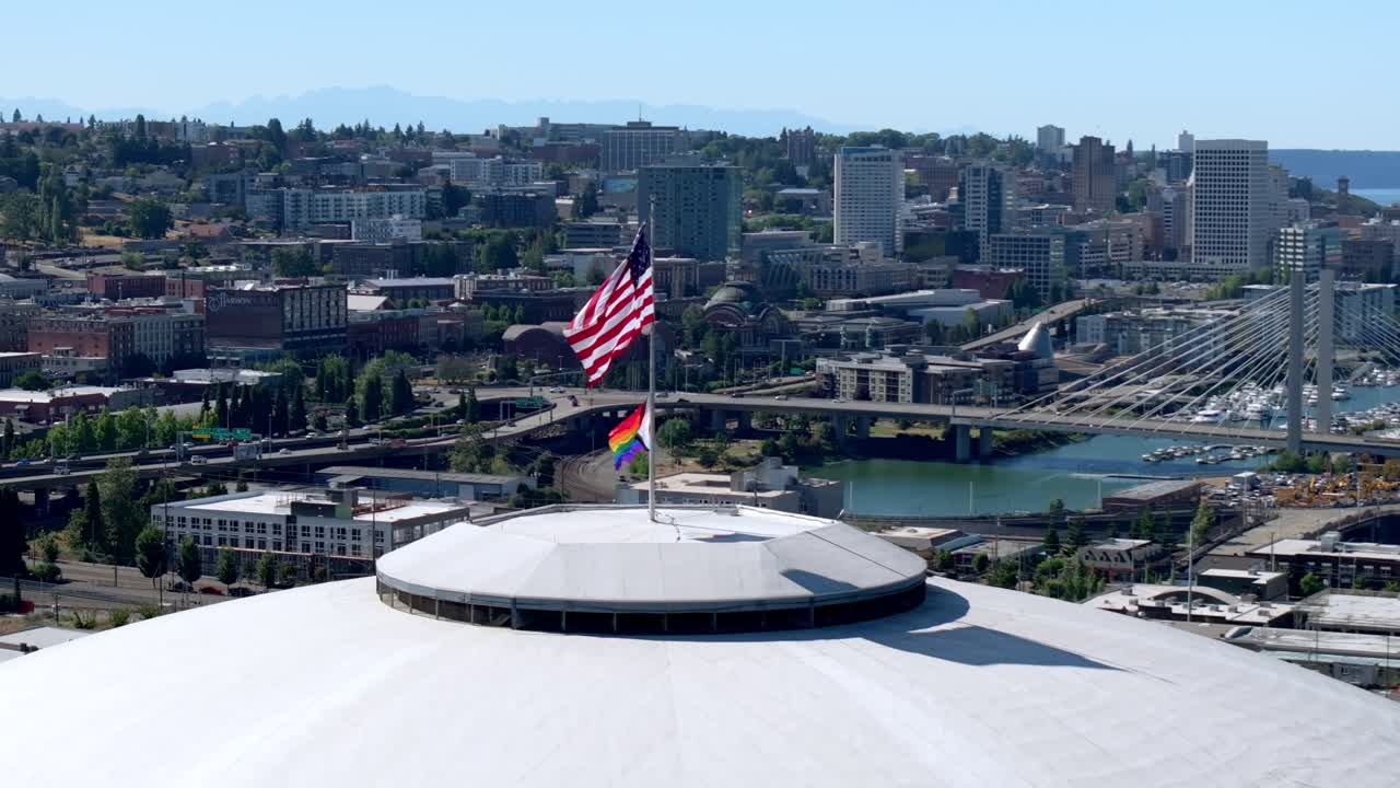 American And Pride Flags On Tacoma Dome With East 21st Street Bridge In The Background In Washington, USA. - aerial shot