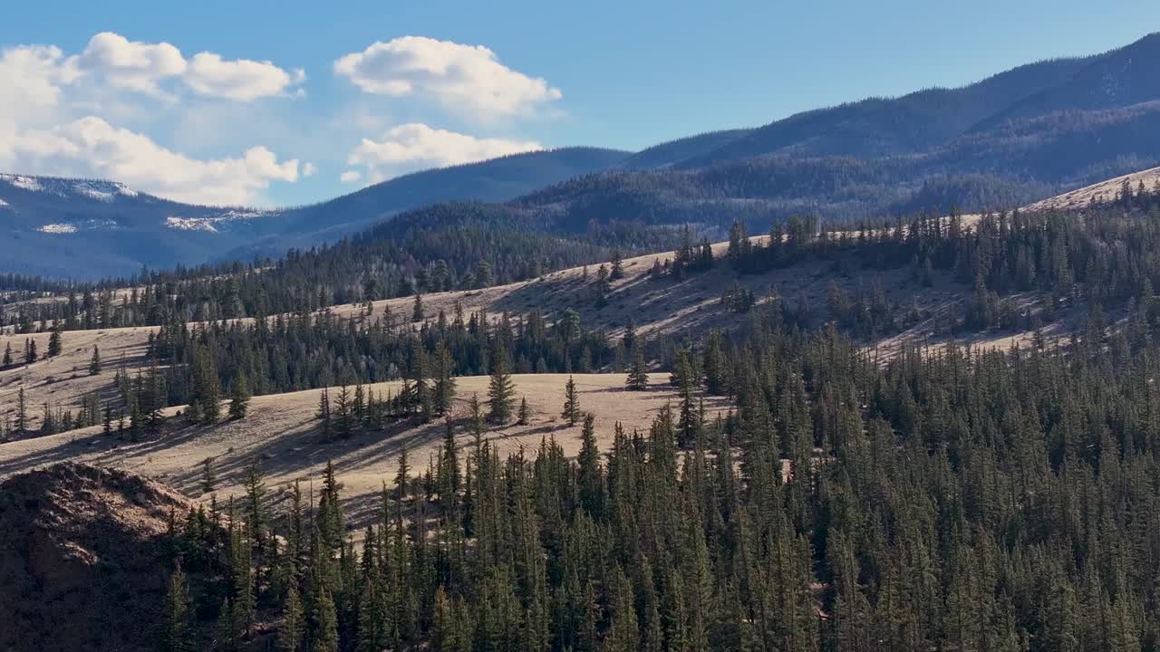 A cinematic, 70mm zoomed-in aerial shot of the beautiful and colorful landscape of Colorado, near the infamous mining town of Creede, Colorado.