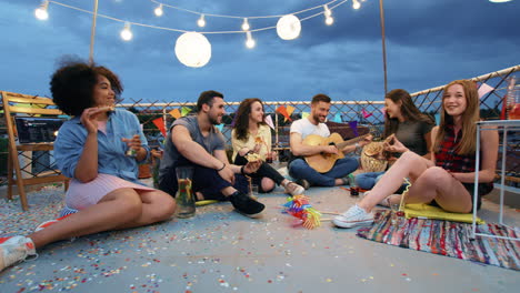 rooftop party friends enjoying music