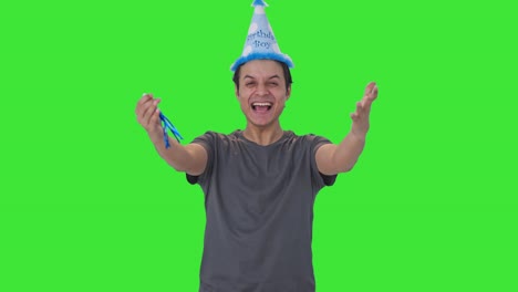 Happy-Indian-man-blowing-birthday-whistle-Green-screen