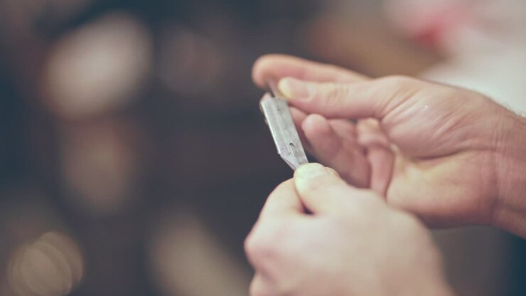 Barber preparing cutthroat razor. Straight razor shave. Barber accessories