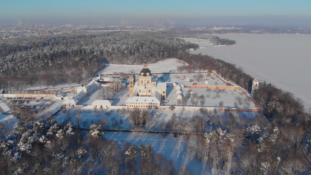 Aerial view of the Pazaislis monastery and the Church of the Visitation in Kaunas, Lithuania in winter, snowy landscape, Italian Baroque architecture, zooming in, crane shot, dolly zoom