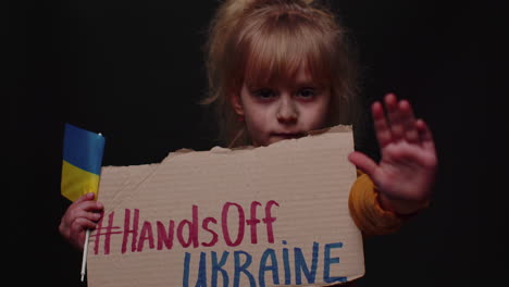 portrait of ukrainian girl child with massage inscription text on map hands off ukraine, crisis, war