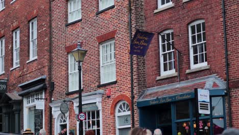 a child rides on father's shoulders in arundel