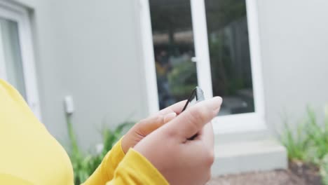 happy african american plus size woman, using smartphone in garden