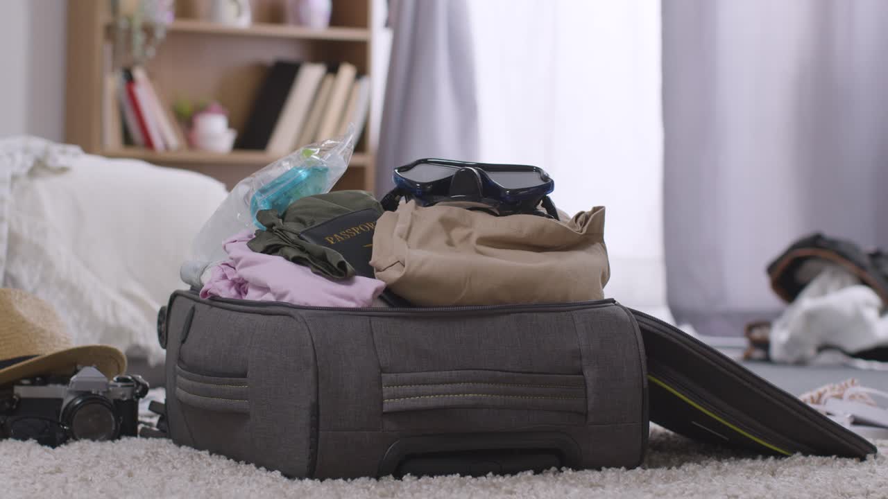 Open Suitcase In Bedroom At Home Being Packed For Summer Holiday