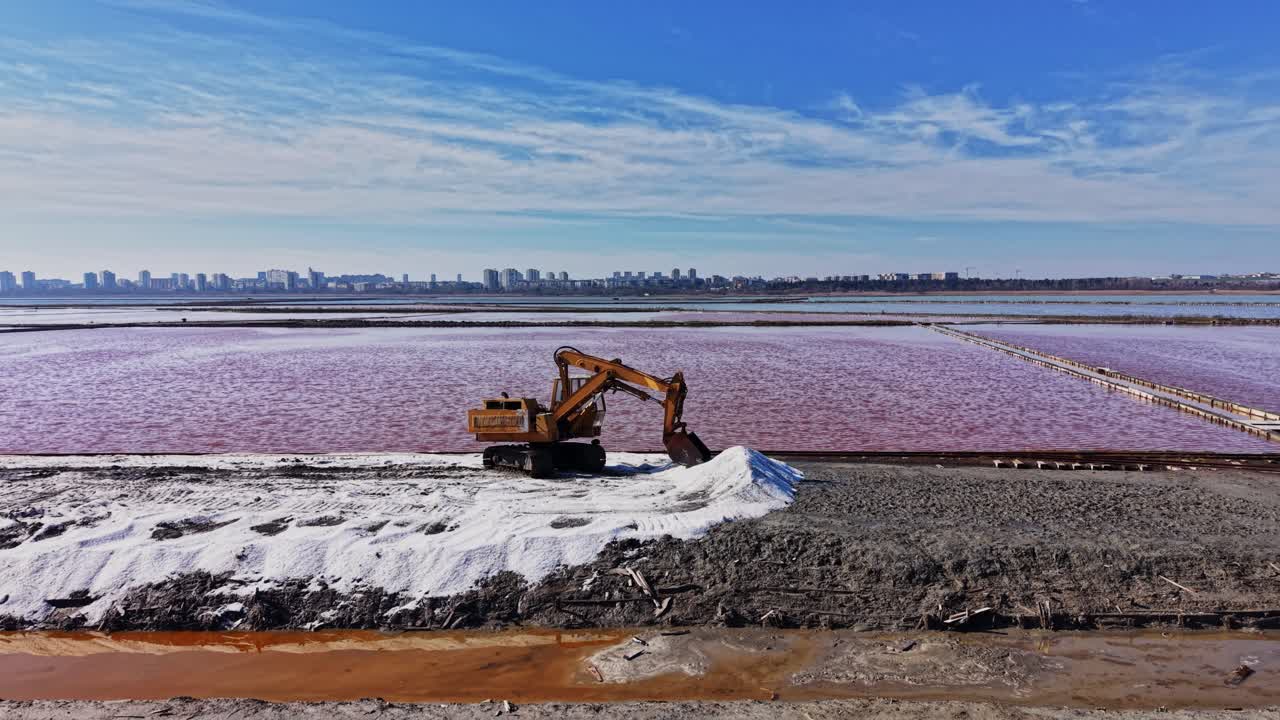Operazione mineraria in una miniera di sale vicino alla città con acqua rosa e macchinari