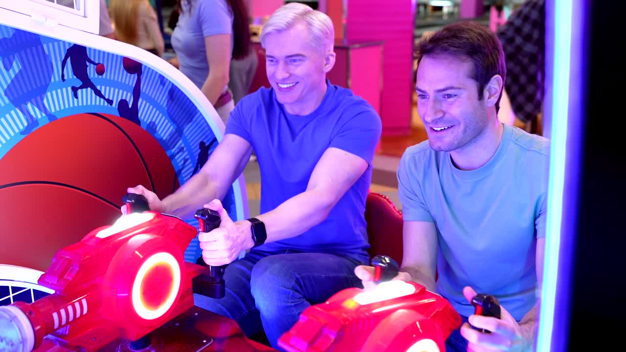 Two Men Playing Arcade Game