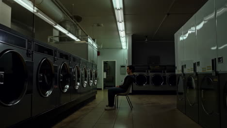 a man waiting in a laundromat