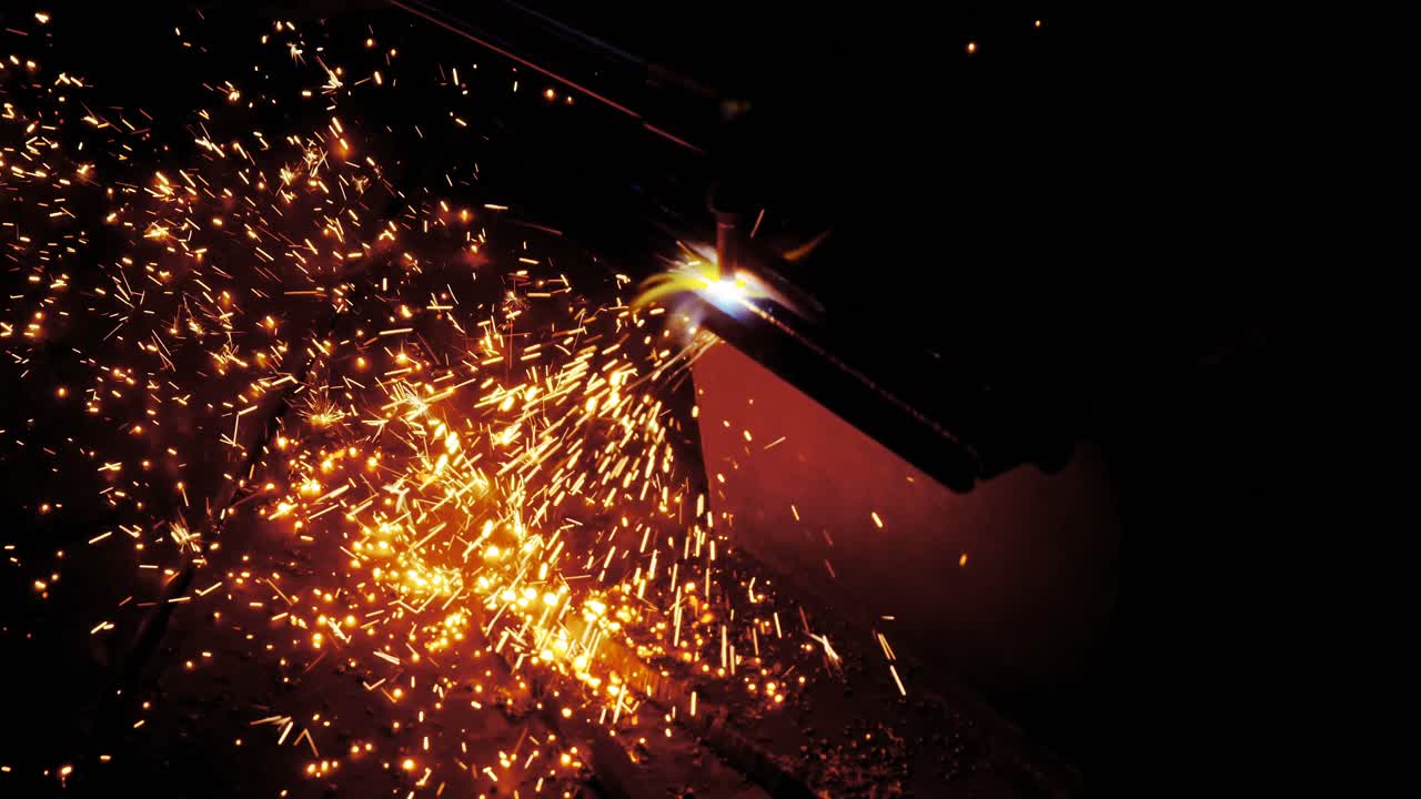 Male engineer using welding torch 4k