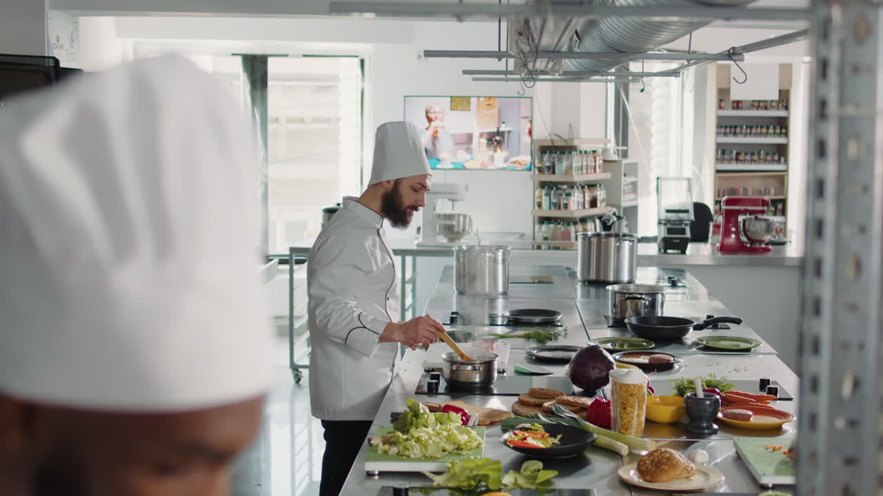 Male cook doing taste test with delicious sauce on stove