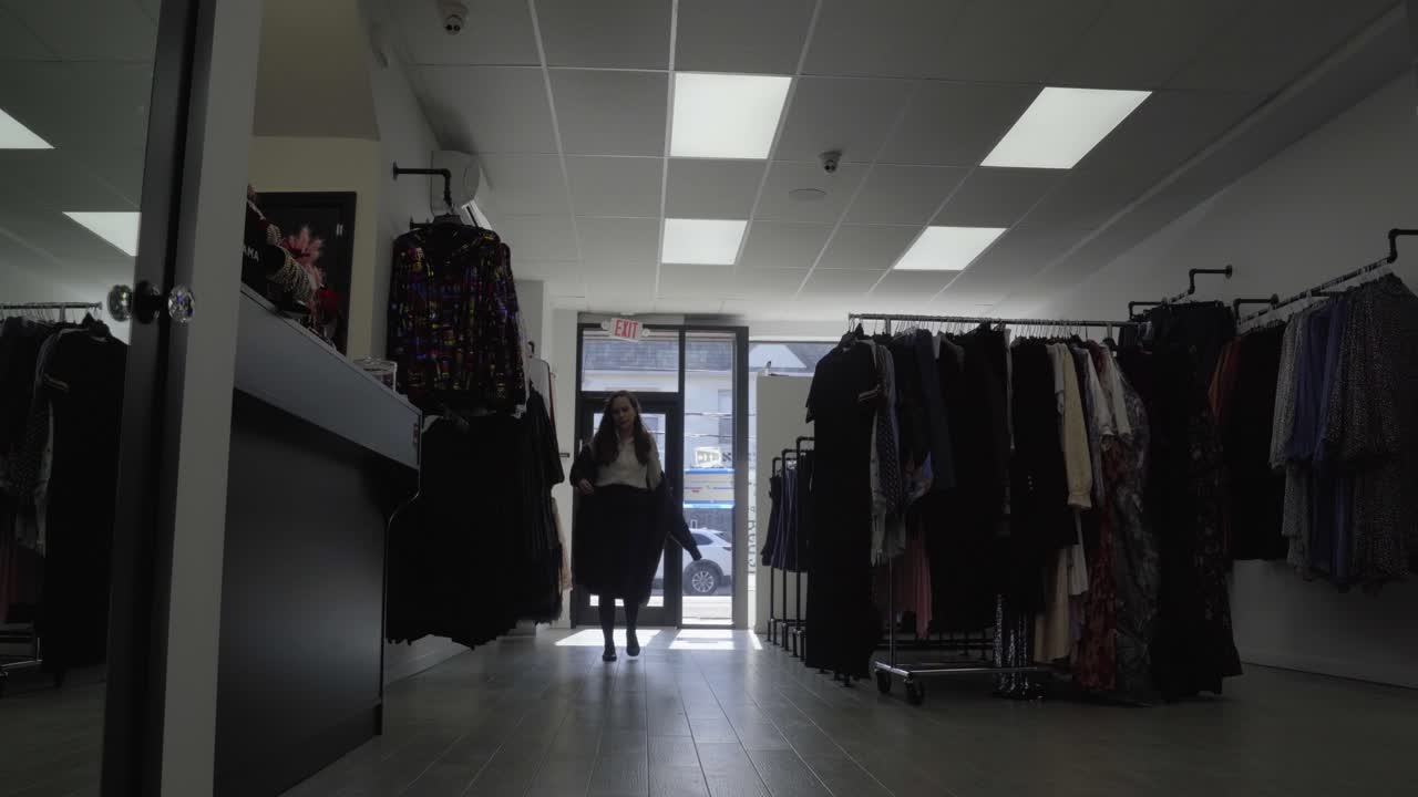 Woman entering store and taking off her coat