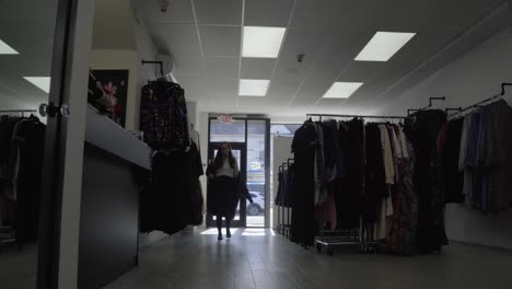 woman entering store and taking off her coat
