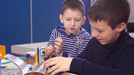 boys building a robot