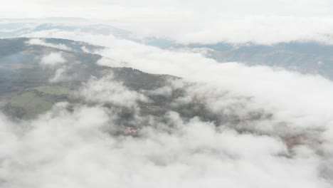 pull lateral with drone above clouds in a misty sunrise in colombia