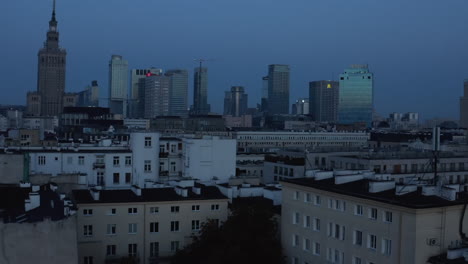 Rising-footage-of-skyline-with-modern-downtown-skyscrapers-and-historic-Russian-style-PKIN-building.-Warsaw,-Poland