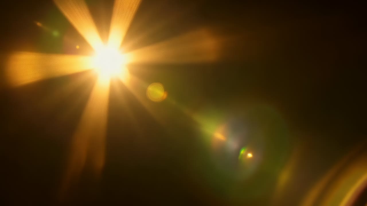 Glowing core emitting starburst as camera shifting, sending diagonal ghosts on black, copy space