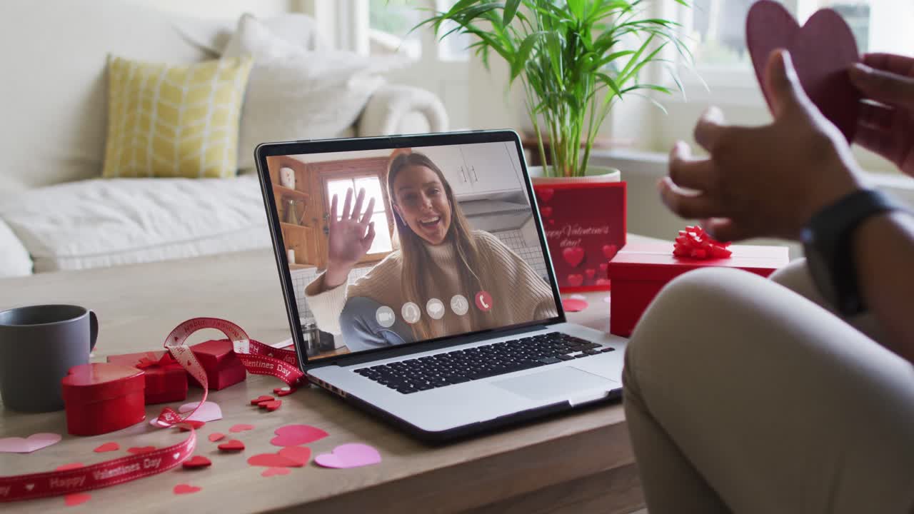 Happy caucasian woman waving and making valentine's day video call on laptop