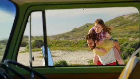 man giving piggyback ride to woman on beach 4k