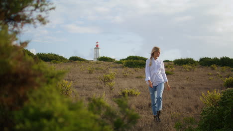 Attractive-lady-stepping-hills-vertically.-Happy-girl-walking-meadows-autumn-day