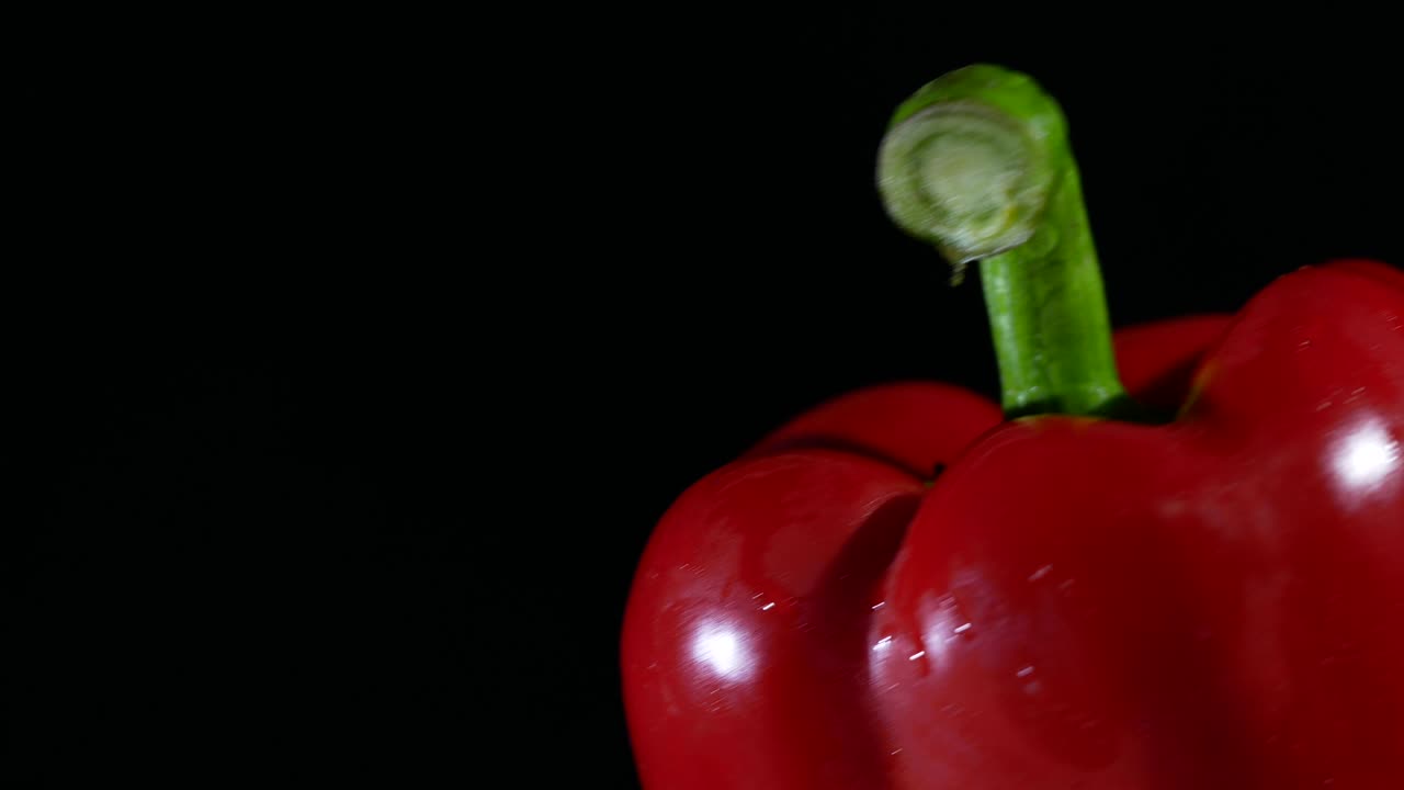 Bell pepper turning on black background