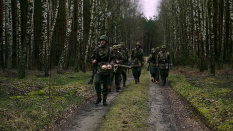 german soldiers marching through a forest