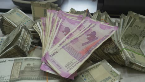 stack of indian rupee banknotes of different value, indian currency, cash, 2000 and 500 rupee note, closeup shot