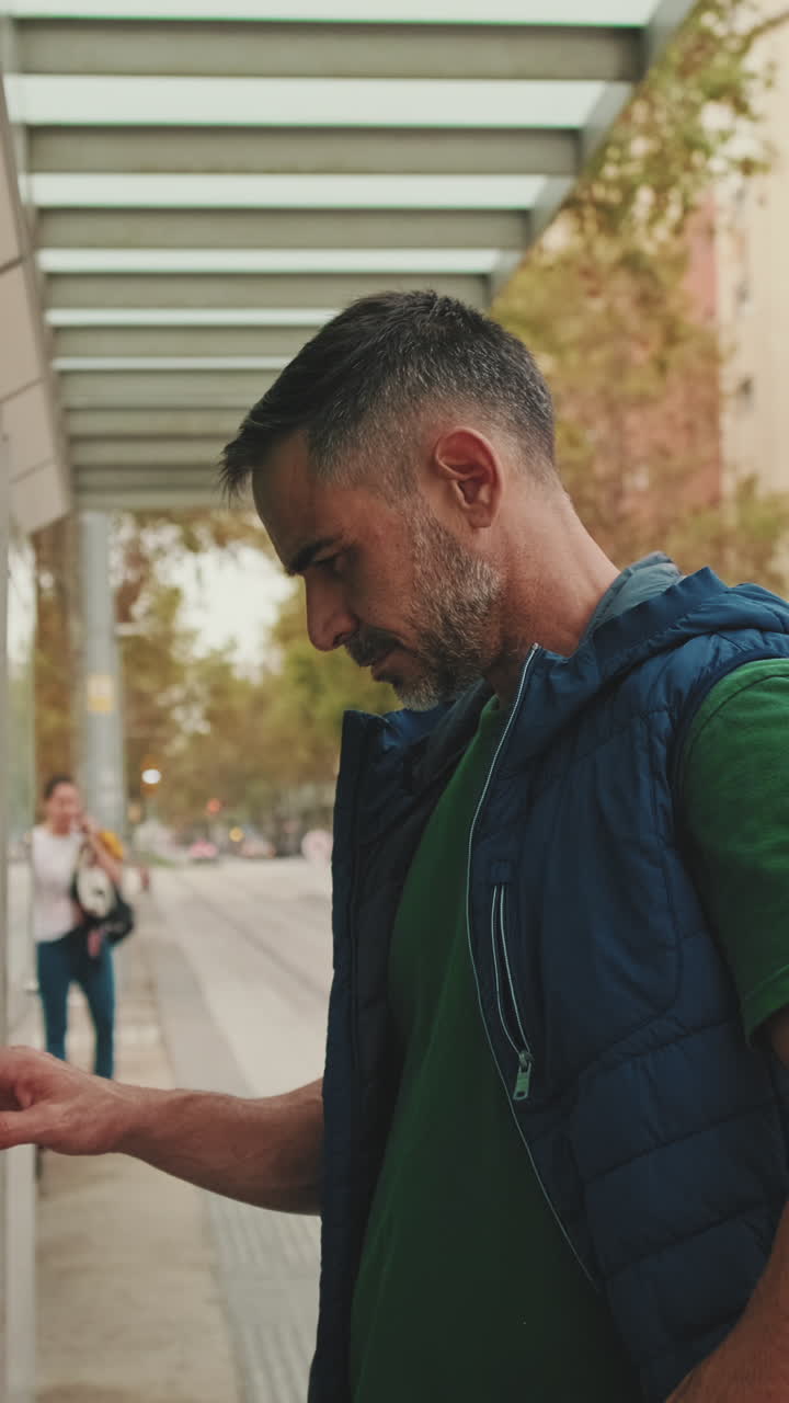 Man at a bus stop in the city