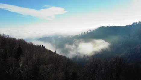 Fliegen-über-Ein-Bergtal-Mit-Niedrigen-Wolken