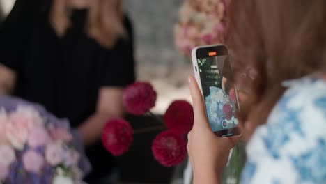woman taking a video of flower bouquets