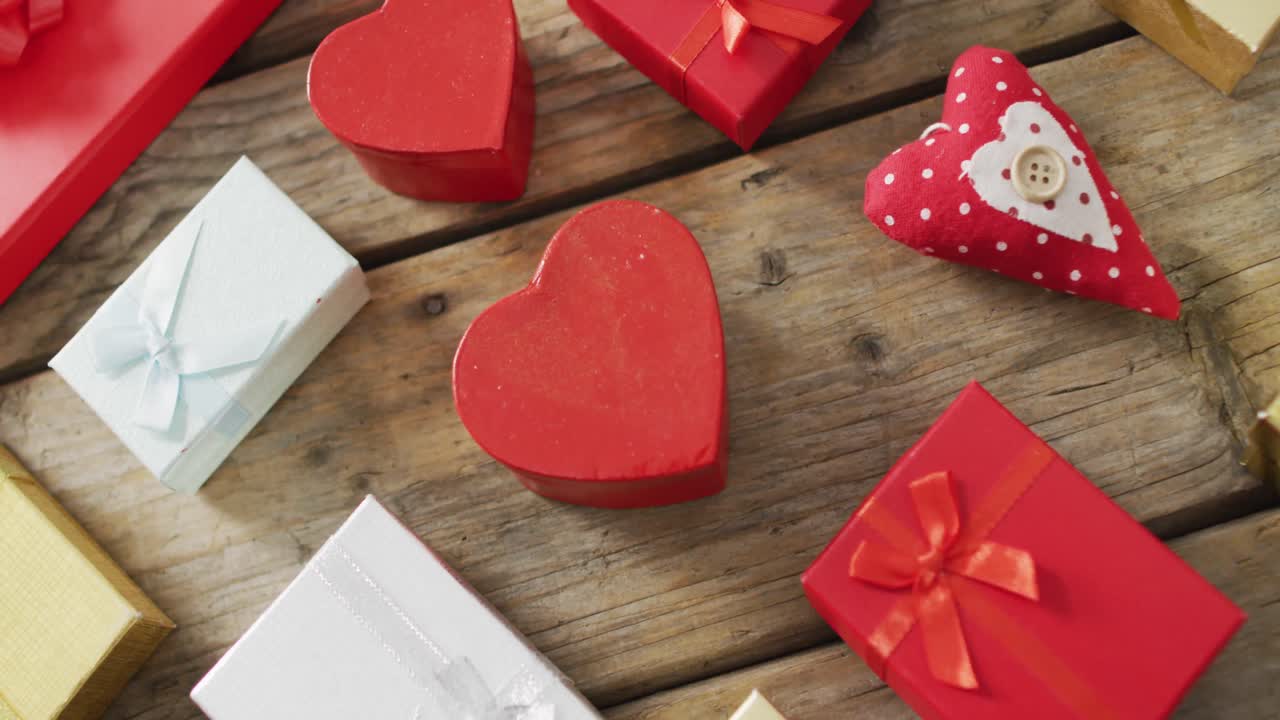 Wooden hearts and gifts on wooden background at valentine's day