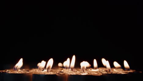 Background-of-tea-cup-glitter-Candles-Lights-shines-yellow-gold-bright-for-celebration,-religion,-anniversary-Festival