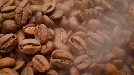 Close-up-of-seeds-of-coffee.-Fragrant-coffee-beans-are-roasted-smoke-comes-from-coffee-beans.