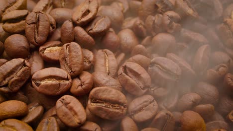 cerca de las semillas de café. los granos de café perfumados son tostados el humo viene de los granos de café.