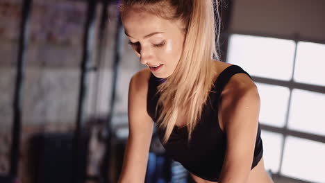 Determined-Young-Woman-Cycling-On-Stationary-Bike-At-Fitness-Studio-4