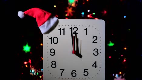 clock in branches of new year's fir on black background. second hand moves in circle of mechanical clock and show twelve o'clock at  midnight and eve of christmas. holiday concept, time lapse, closeup, close-up