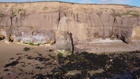 Sea-Stack-at-Ryhope-Cliffs-Hendon-Beach-in-Sunderland-North-East-UK,-Aerial-Drone-4K-HD-Rotate-Left