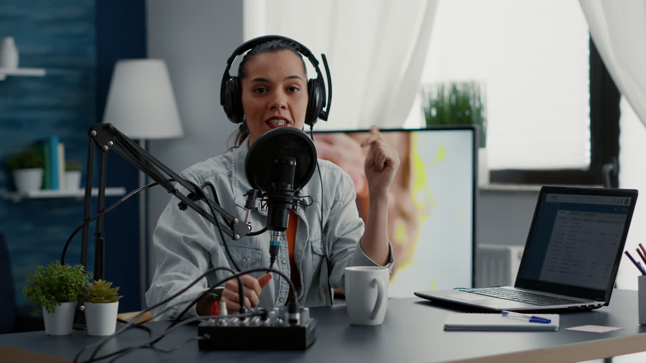 Famous social media influencer tweaking knobs on mixer while recording vlog