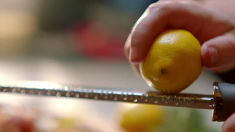 A person is grating a lemon