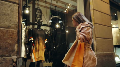 tourist woman looking in shop windows. closeup girl walking with shopping bags