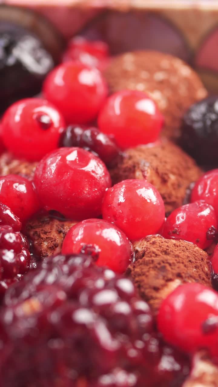 Primo piano di un delizioso dessert con ribes rossi, more e cioccolato