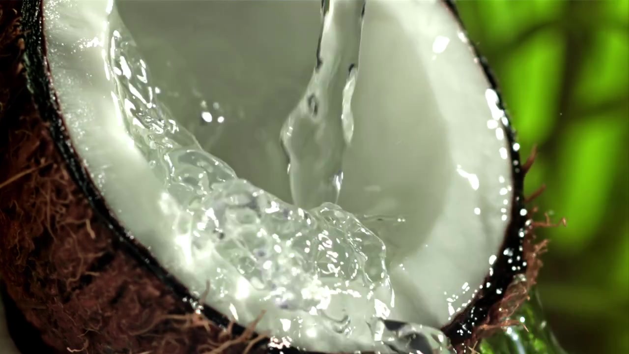 Fresh Coconut Water Pouring and Splashing in Slow Motion