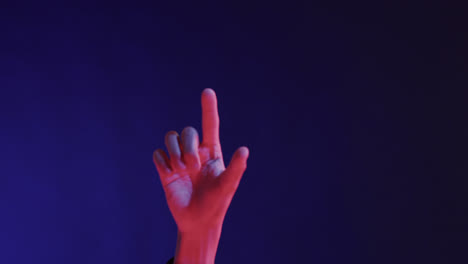 hand of asian man, touching virtual screen on blue background, copy space, slow motion