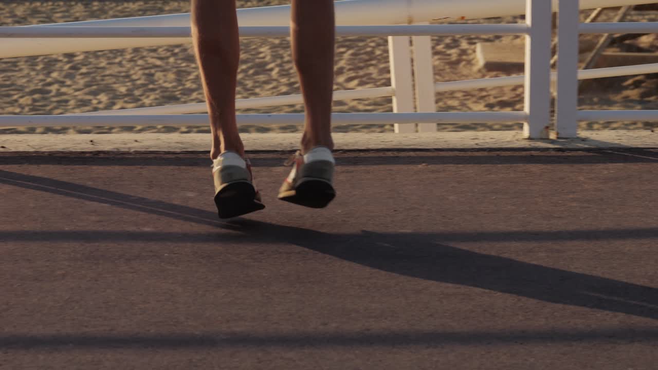 Woman's legs jumping on a beach