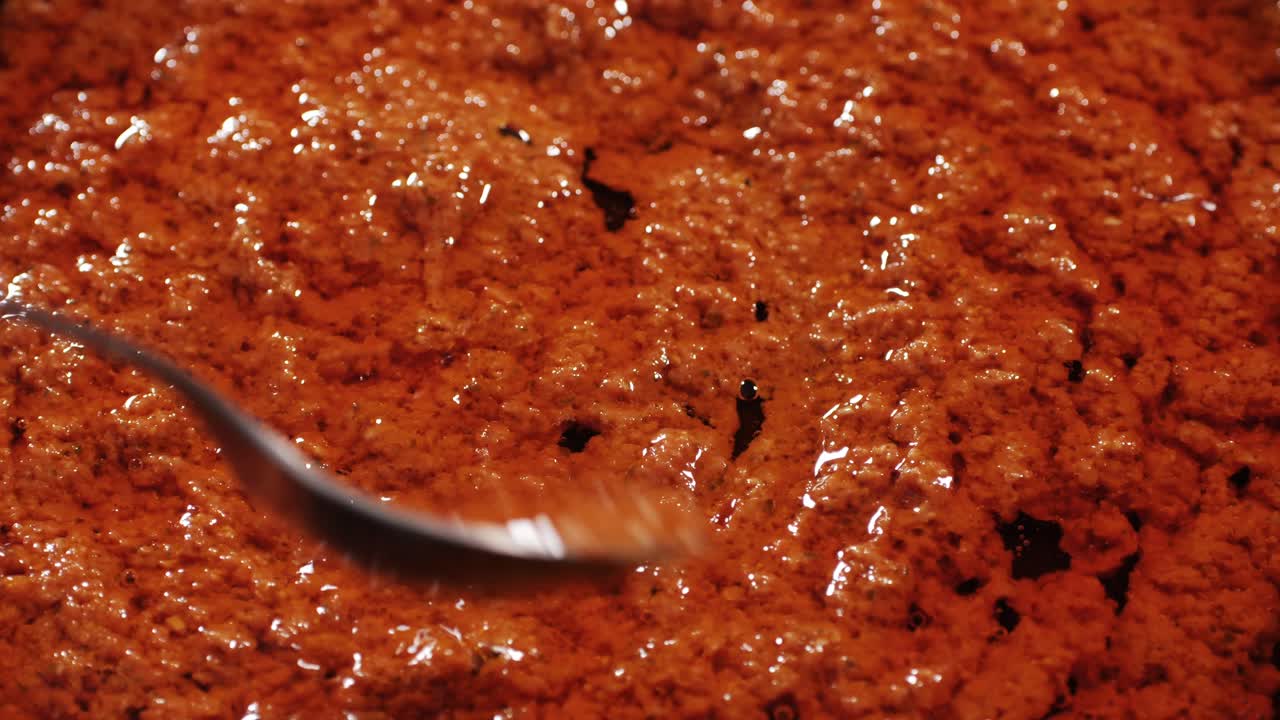 Cooking tomato sauce close-up. Classic homemade Italian tomato sauce for pasta and pizza in the pan. Chef cooking traditional Italian food. High quality 4k footage