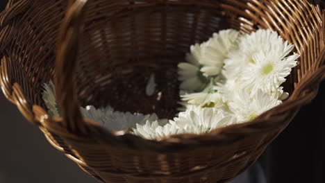 close up shot of a wicker basket with white flowers