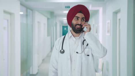 happy sikh indian doctor talking on call