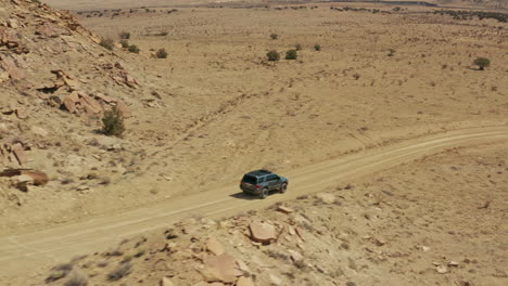 Aerial-following-4x4-Toyota-4Runner-down-desert-dirt-road-in-New-Mexico