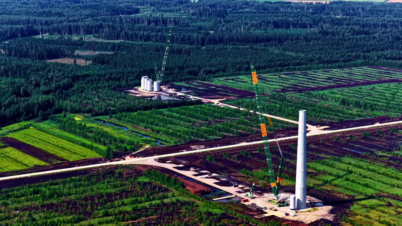 Under construction renewable wind turbine farm building site green energy, aerial drone