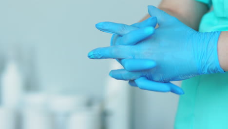 close-up of the doctor wearing rubber gloves